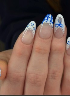 French tip nails with hand-painted blue bows