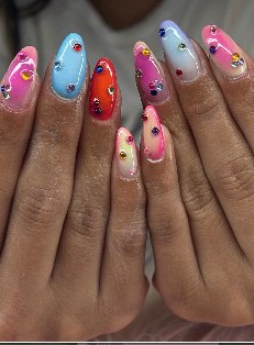 Multicolor pastel nails with scattered gems and crystals